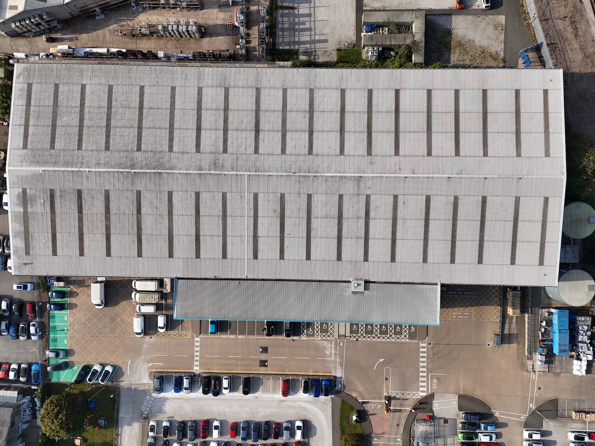 Overhead drone view of industrial roofing showing layout and condition