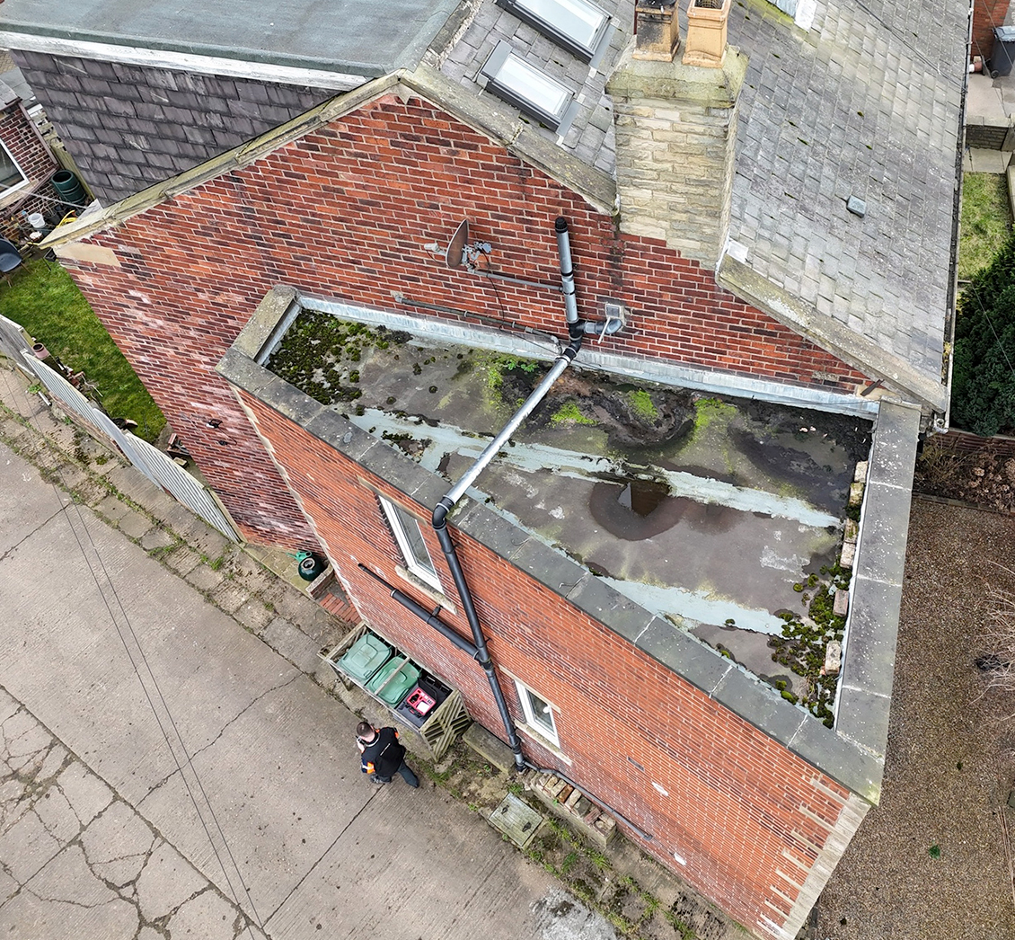 Flat roof surface detail showing membrane condition from drone inspection